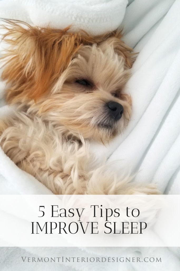 Dog sleeping on crisp white linens 