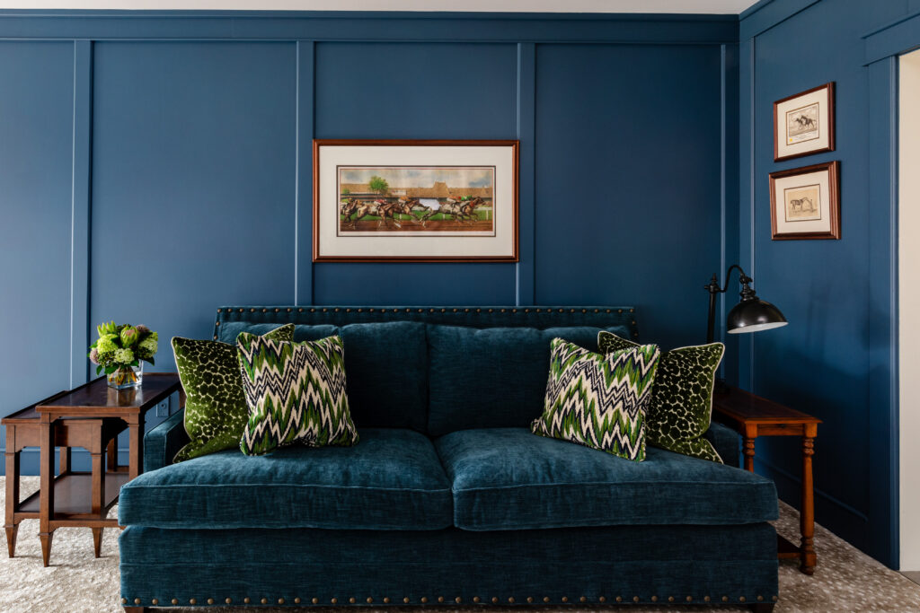 Blue sofa and blue wall with artwork